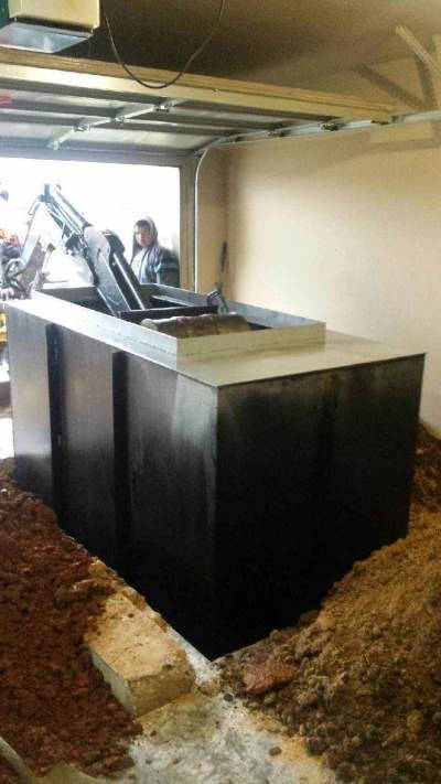 An underground storm shelter being installed.