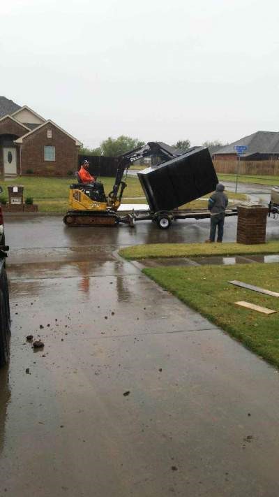 man installing an underground garage shelter