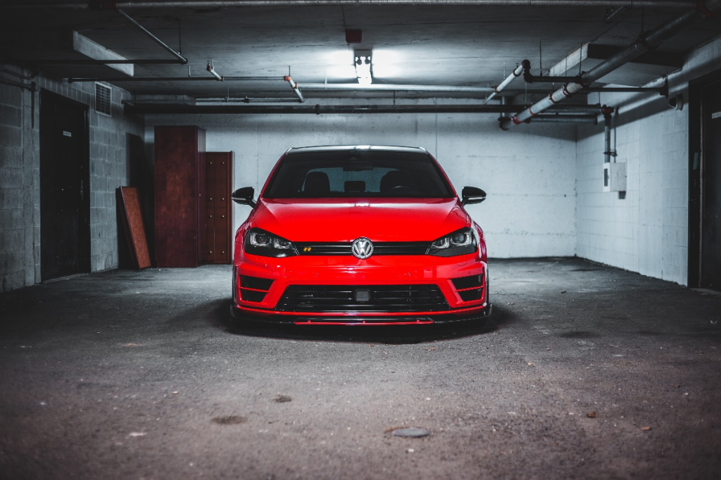 Red car parked in an underground garage shelter 