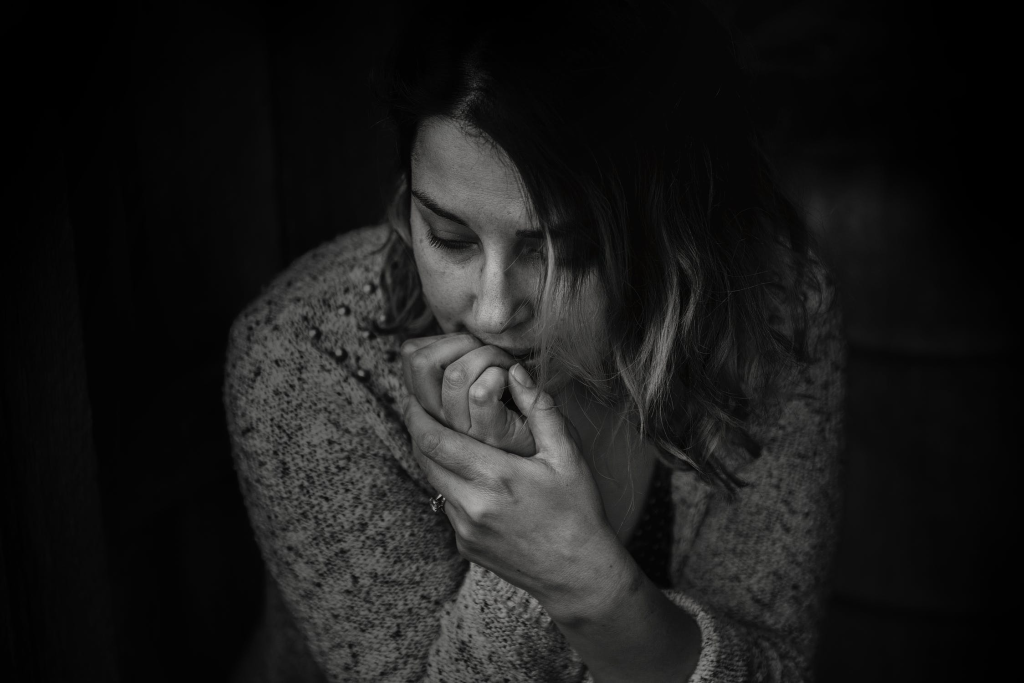 a girl biting nails due to anxiety