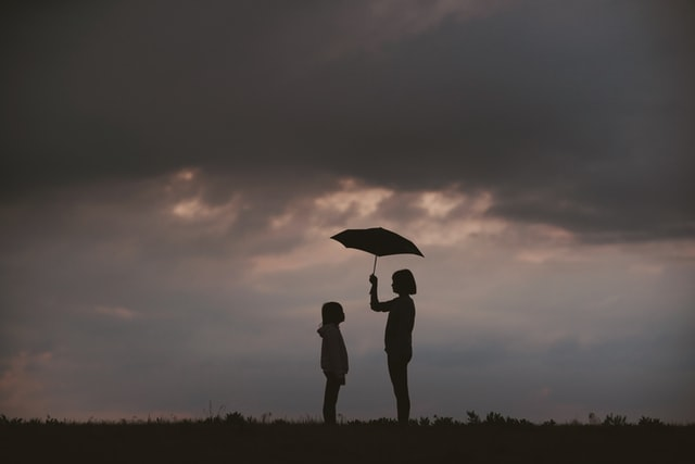 kids standing outside as the bad weather approaches