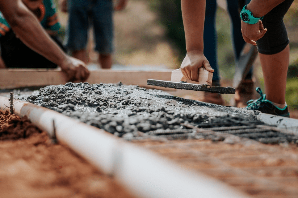 Workers leveling the cement.