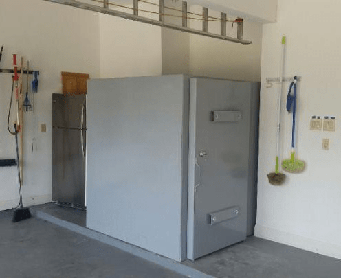 A large grey metal safe room indoors