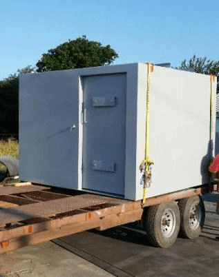 Truck carrying a steel safe room.