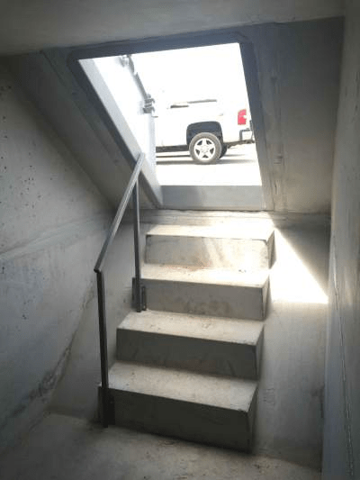 An image of stairs going down into a storm shelter
