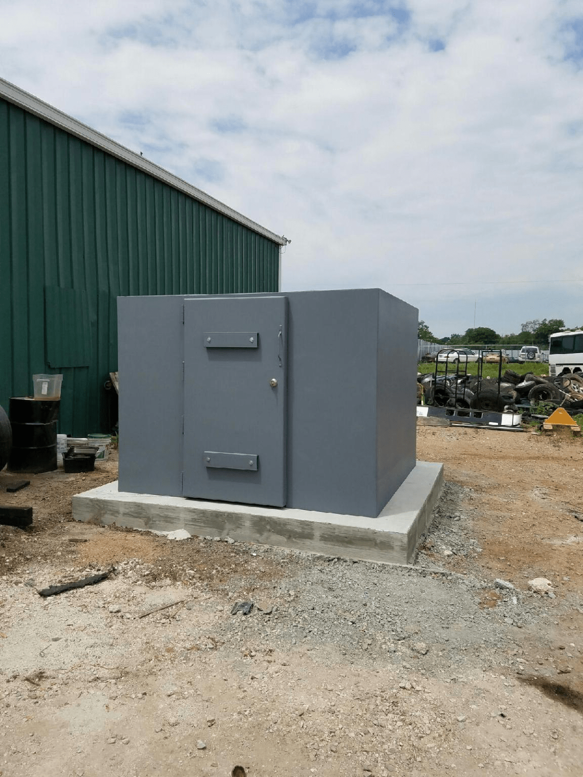 A brand new steel safe room placed on a slab, ready to be installed.