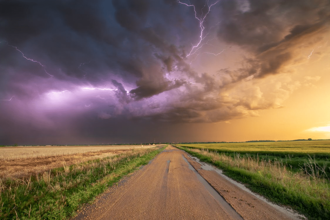 Lightning storm over open land and a country road