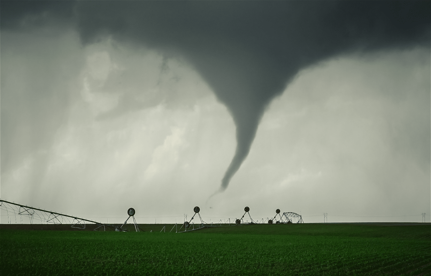 Funnel cloud extending from a dark storm base