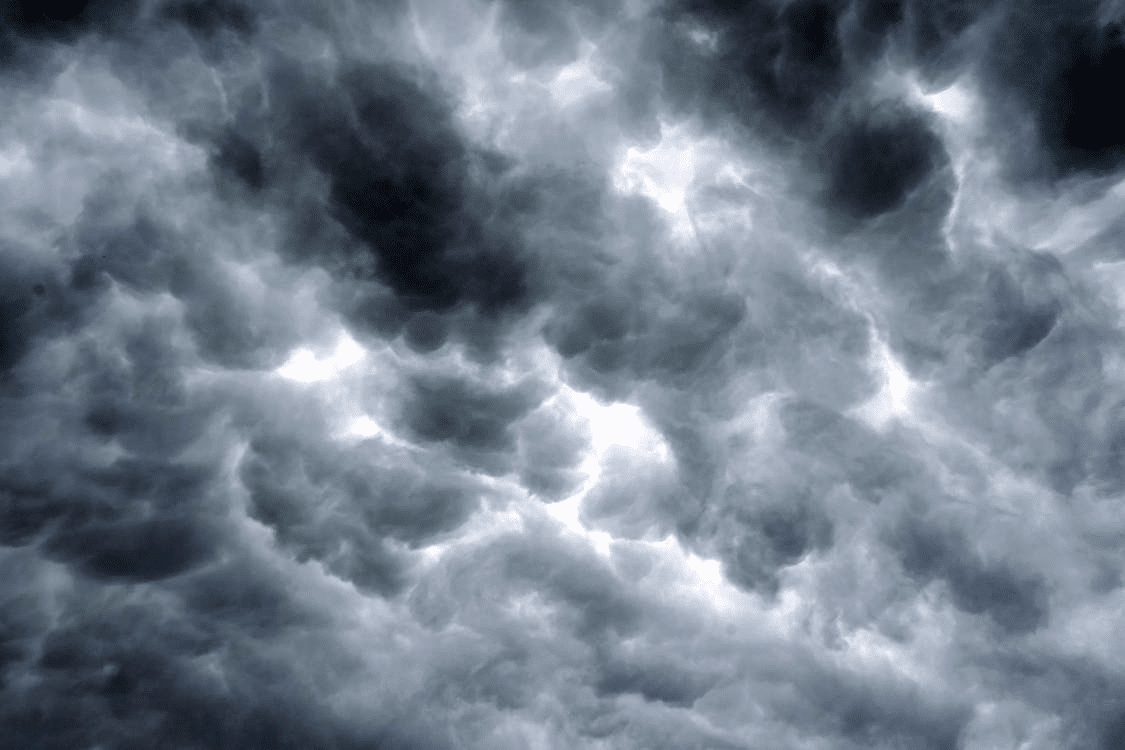 Dark storm clouds filling a moody, overcast sky