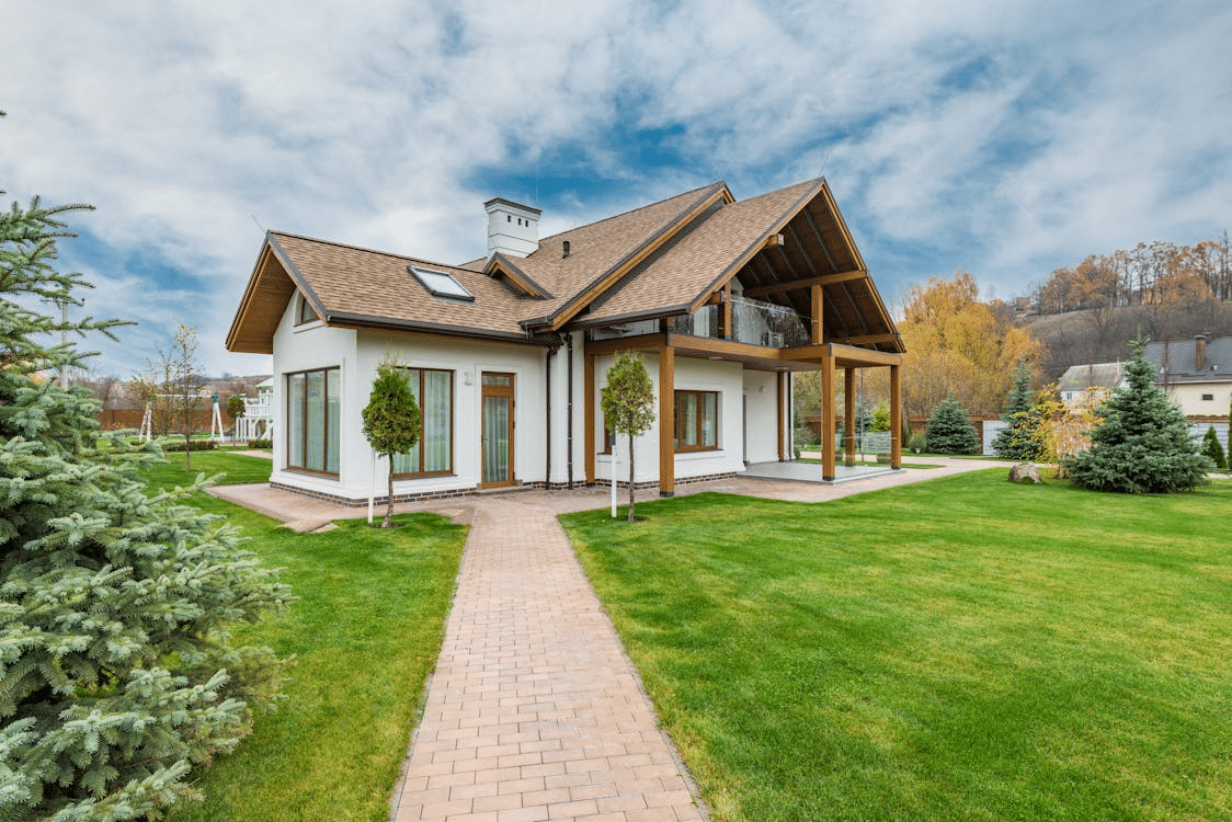Contemporary residential home with spacious lawn and tall windows in a suburban setting