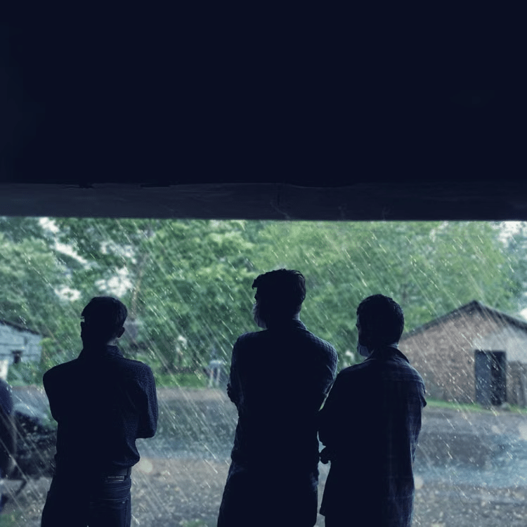 Employees gathering near a commercial storm shelter at a business property.