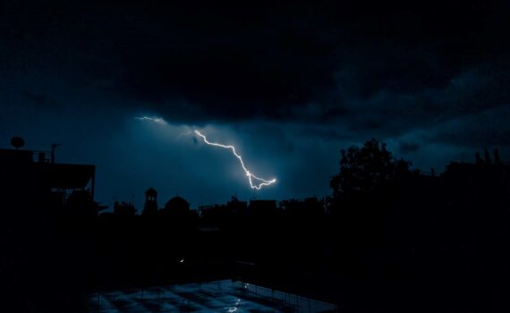 Lightning strikes over a dark landscape