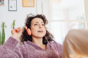 A woman wearing headphones and listening to music