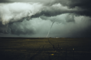 Tornado forming over an open field