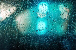 Rain drops splattered against the window of a car