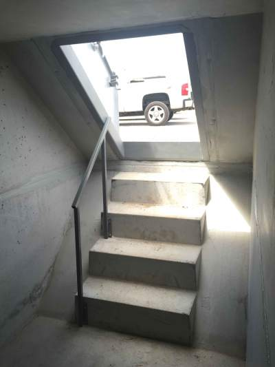 A stairway leading to an in-ground storm shelter