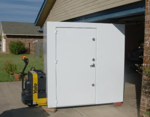 An above-ground storm shelter made from steel