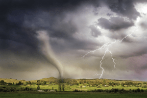 a tornado and lightning hitting an open field