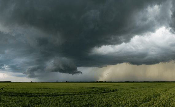 clouds over a green field before a tornado.