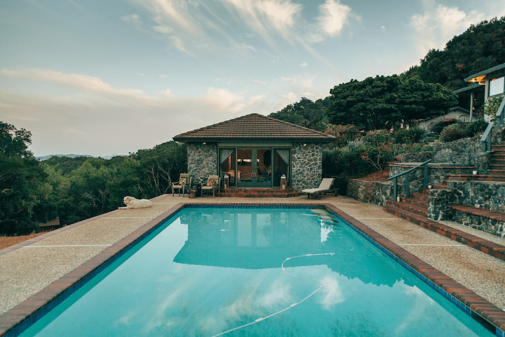A house on the cliff with a large swimming outdoor pool.