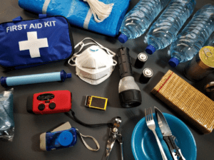 An emergency survival kit laid out with its contents.