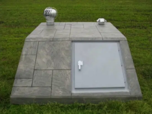 A concrete shelter installed in a backyard.