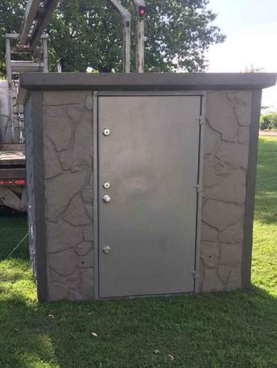 A gray concrete storm shelter