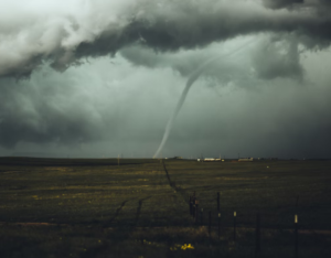 A narrow rope-like tornado in the distance