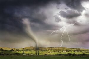 Lightning and a tornado hitting an open field