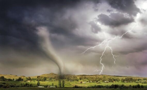 Lightning and a tornado hitting an open field
